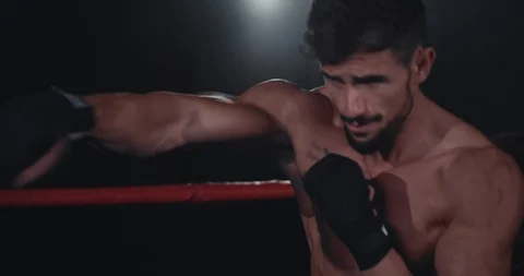 In the middle of boxing ring beautiful fit body guy have a intense workout Stock Footage 117054516