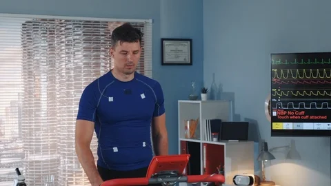 Middle close-up of ethlete changing treadmill speed during cardiac stress test Stock Footage 114078682