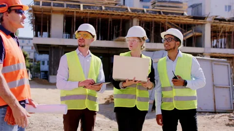 In the middle of construction site group of young specialists in construction Stock Footage 146600230