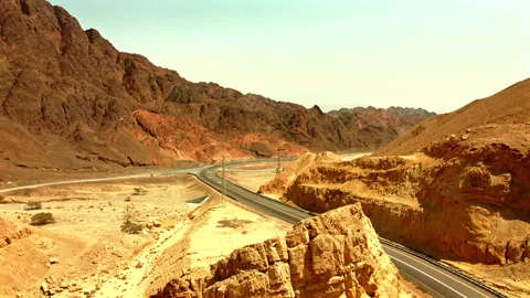 Middle of the desertmountains from each side and highway road split them Stock Footage 272447443