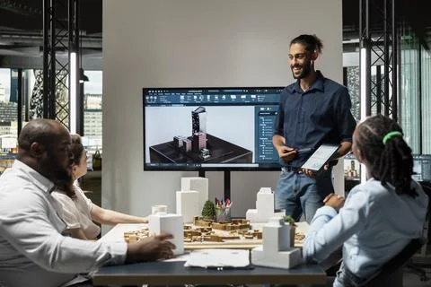 Middle eastern architect shows blueprints and software for construction plan Stock Photos