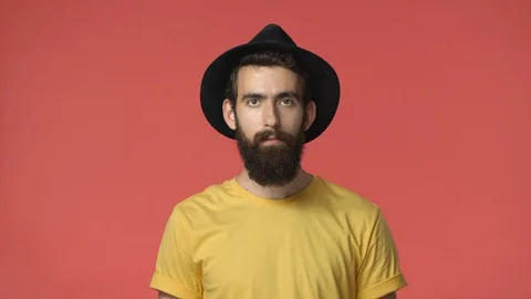 Middle-eastern attractive enthusiastic bearded jewish guy in hat, yellow t-shirt Stock Footage 115778173