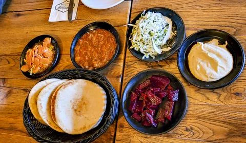 Middle Eastern bread served with spiced meat and vegetable salad. Stock Photos