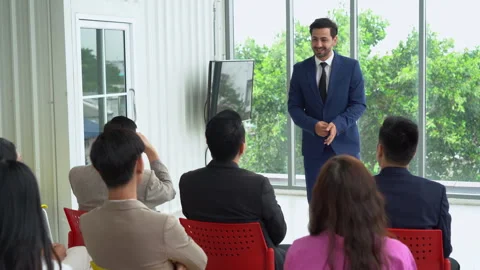 Middle eastern business man standing and talking in font of group of divers.. Stock Footage 254880313