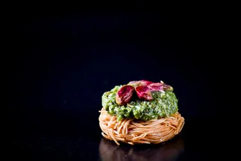Middle Eastern dessert called mabroume or burma isolated on black background. Stock Photos