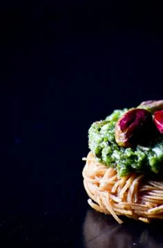 Middle Eastern dessert called mabroume or burma isolated on black background. Stock Photos