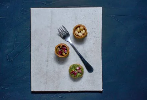 Middle Eastern dessert with pistachio called mabroume or burma isolated on bl Stock Photos