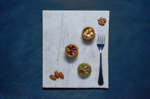 Middle Eastern dessert with pistachio called mabroume or burma isolated on bl Stock Photos
