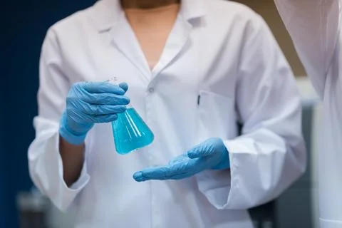Middle Eastern doctors and medical technician handling blue liquid in blood 스톡 사진