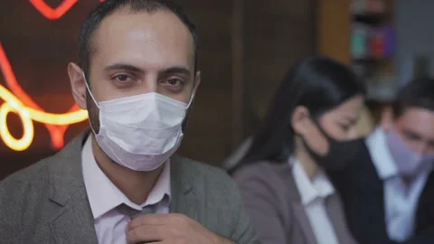 Middle Eastern ethnicity freelancer in a protective mask works in the office Stock Footage 130577310
