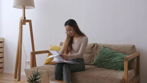 Middle Eastern female remote working from home, checking documents. Stay home Stock Footage 148876990