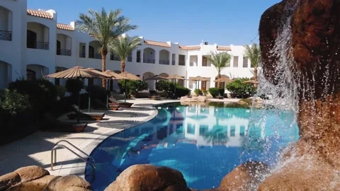 Middle Eastern Hotel Courtyard With A Swimming Pool And Artificial Waterfall Stock Footage 218579688
