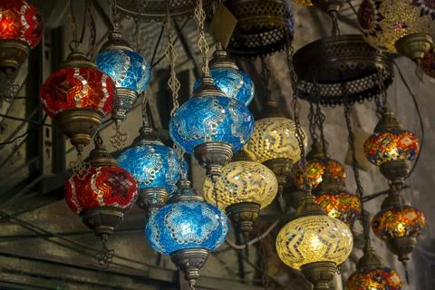 Middle Eastern lambas of different colors and sizes are hanging in the bazaar. Stock Photos