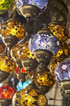 Middle Eastern lambas of different colors and sizes are hanging in the bazaar. Stock Photos