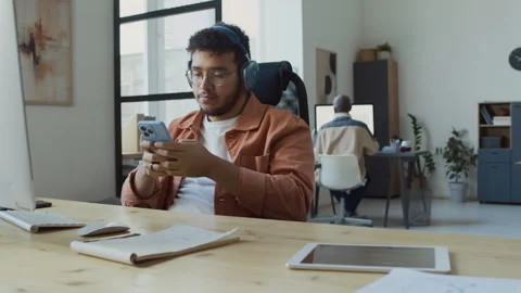 Middle Eastern Male Software Developer Enjoying Music at Work Stock Footage 293123901