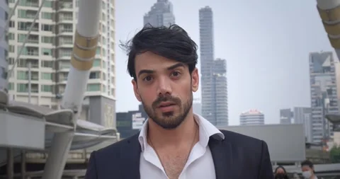 Middle Eastern man on bussines city street. Noticing something unusual, face Stock Footage 312500110