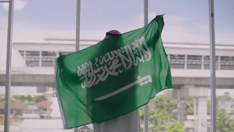 Middle eastern man celebrating with the flag of saudi arabia Stock Footage 274819584