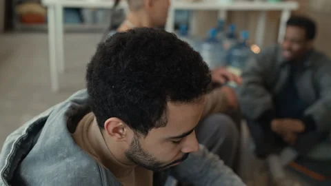Middle Eastern Man Drinking Water from Bottle at Humanitarian Aid Center Vídeo Stock 339071122