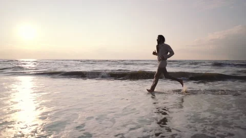 Middle Eastern man running on the shore ... | Stock Video | Pond5
