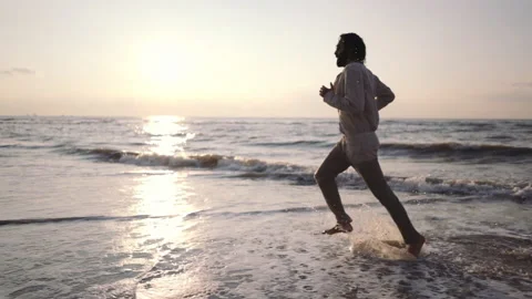 Middle Eastern man running on the shore ... | Stock Video | Pond5