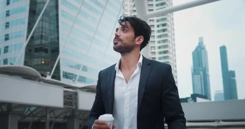 Middle eastern man takes coffee break after hard office work in urban streets Stock Footage 312503590