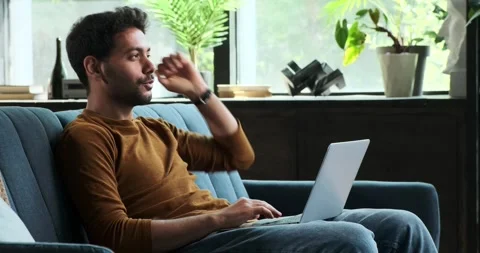Middle Eastern Man Using Laptop on Sofa in the Living Room Video stock 254435608