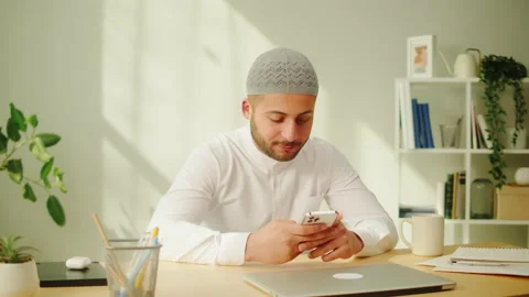 Middle eastern man using smartphone, home office. Male person texting at phone Stock Footage 198218662