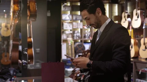 A Middle Eastern Man Using Smartwatch To Purchase Product Stock Footage 120382345
