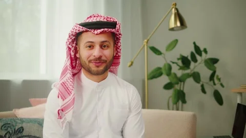 Middle eastern man using virtual conference. Male person in earphones talking on Stock-Footage 197372266