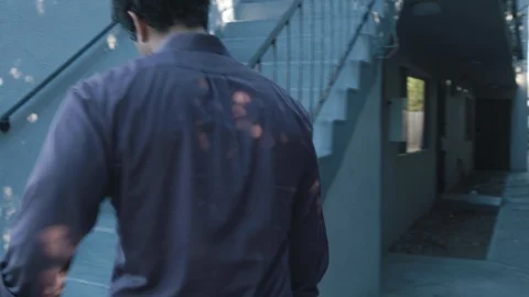 Middle eastern man walking up outdoor apartment stairs at affordable housing Stock Footage 89252829