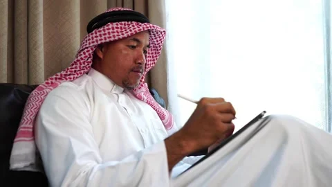 Middle eastern man working on sofa Stock Footage 229474630