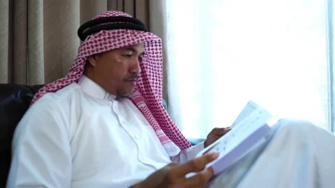 Middle eastern man working on sofa Stock Footage 229475397