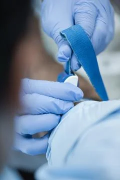 Middle Eastern medical technician preparing a blood test with gloved hands and 스톡 사진