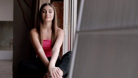 Middle eastern model posing for the camera in the studio on the windowsill  Stock Footage 228651358