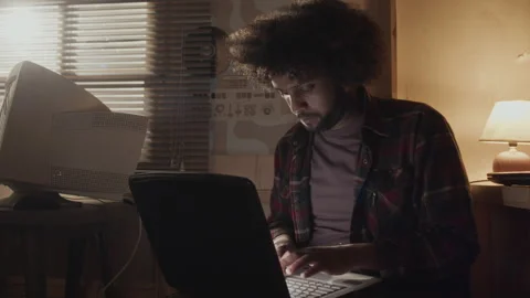 Middle Eastern Nerd with Messy Curly Hair Typing on Old Laptop Stock Footage 263297959