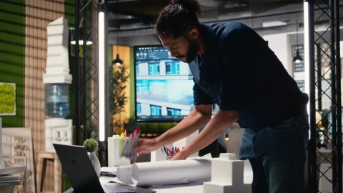 Middle eastern real estate developer evaluates construction site blueprints Stock Footage 316649807