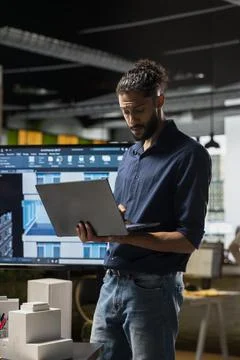 Middle eastern real estate developer evaluates construction site blueprints Stock Photos