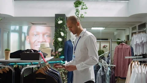 Middle eastern retail worker sorting new collection of merchandise Stock Footage 319577452
