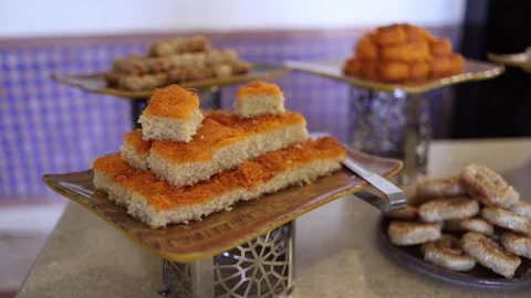 Middle Eastern semolina cake topped with crispy kunafa stacked slices dessert bu Stock Footage 310535960