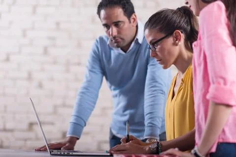Middle Eastern startup team collaborating in a creative coworking office around Stock Photos