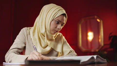 Middle Eastern student in hijab prepares for test while studying at home Stock-Footage 343986250