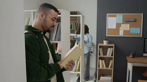 Middle Eastern Student Reading Book in University Library Stock Footage 337478813