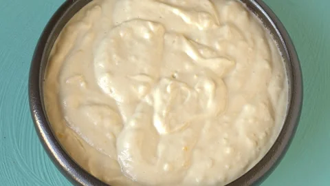 Middle Eastern tahini dip with garlic and lemon rotating flat lay top view. Stock Footage 342277215