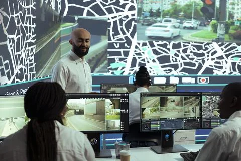 Middle eastern team leader instructs staff to monitor delivery trucks activity Stock Photos