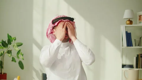 Middle eastern tired man using laptop. Home office. Male person working at Stock Footage 198224582