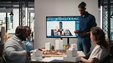 Middle eastern urban developer presenting blueprints master plan to colleagues Stock Footage 316796152