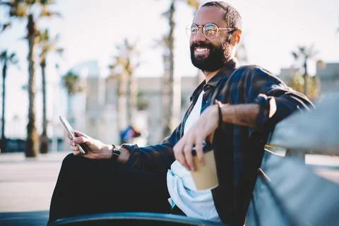 Middle Eastern user in sunglasses connecting to 4g for browsing content Stock Photos