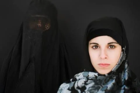 Middle Eastern woman in burka and teenager in headscarf Stock Photos