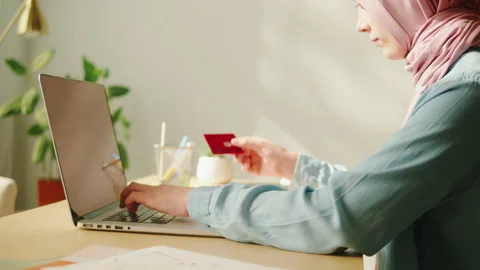 Middle eastern woman using credit bank card and laptop. Online shopping. Female Stock Footage 201273740