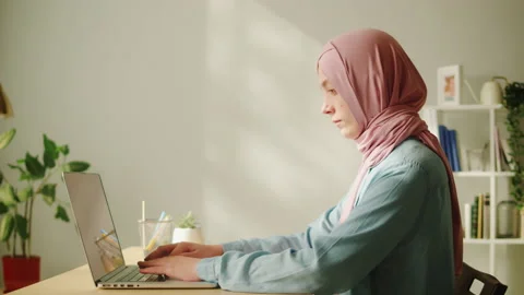 Middle eastern woman using laptop, remote work. Home office. Texting at computer Stock Footage 197375187
